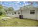 Backyard of a single-story home with a concrete patio and AC unit at 6780 Nw 60Th St, Ocala, FL 34482