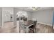 Dining area with adjacent kitchen and wood-look flooring at 6780 Nw 60Th St, Ocala, FL 34482