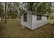 White shed with windows and a door in a backyard at 6780 Nw 60Th St, Ocala, FL 34482