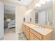 Bright bathroom with double vanity, ample counter space, and tile flooring at 7932 Sw 89Th Cir, Ocala, FL 34481
