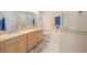 Elegant bathroom with double vanity, walk-in shower with built-in seat, and tile flooring at 7932 Sw 89Th Cir, Ocala, FL 34481
