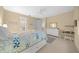 Spacious bedroom with ceiling fan, ample storage space, and a dedicated workspace at 7932 Sw 89Th Cir, Ocala, FL 34481