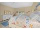 Inviting bedroom with a cozy bed, ceiling fan, and windows providing natural light at 7932 Sw 89Th Cir, Ocala, FL 34481