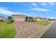 Single-story home with a paved driveway and attached two-car garage at 7932 Sw 89Th Cir, Ocala, FL 34481