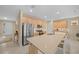 Eat-in kitchen with stainless steel appliances, large island with seating, wood cabinetry, and tile floors at 7932 Sw 89Th Cir, Ocala, FL 34481