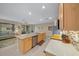 Spacious kitchen featuring stainless steel appliances, a large island with breakfast bar, and wood cabinetry at 7932 Sw 89Th Cir, Ocala, FL 34481