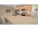 Modern kitchen boasting stainless steel appliances, large island with seating, and tile floors at 7932 Sw 89Th Cir, Ocala, FL 34481