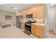 Kitchen with stainless steel appliances, wood cabinets, and tile backsplash at 7932 Sw 89Th Cir, Ocala, FL 34481