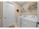 Laundry room with washer, dryer, and storage shelves at 7932 Sw 89Th Cir, Ocala, FL 34481