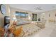Cozy living room with comfortable seating, a rocking chair, and large windows at 7932 Sw 89Th Cir, Ocala, FL 34481