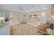 Open-concept living area with adjacent kitchen, dining space, and access to the outdoors at 7932 Sw 89Th Cir, Ocala, FL 34481