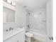 Updated bathroom with a white vanity, marble tiled tub/shower, and modern fixtures at 13573 Sw 115 Pl, Dunnellon, FL 34432