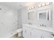 Bright, updated bathroom featuring a double vanity, marble tile shower, and modern fixtures at 13573 Sw 115 Pl, Dunnellon, FL 34432