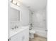 Modern bathroom with white vanity, marble tile tub/shower combo, and updated fixtures at 13573 Sw 115 Pl, Dunnellon, FL 34432