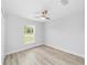 Empty bedroom with wood-look flooring, ceiling fan, and ample natural light at 13573 Sw 115 Pl, Dunnellon, FL 34432