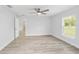Inviting bedroom with wood-look flooring, a ceiling fan, and large window at 13573 Sw 115 Pl, Dunnellon, FL 34432