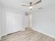 Spacious bedroom with wood-look floors, ceiling fan, and closet at 13573 Sw 115 Pl, Dunnellon, FL 34432