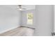 Inviting bedroom with wood floors, large window, and ceiling fan at 13573 Sw 115 Pl, Dunnellon, FL 34432