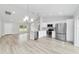 Open-concept kitchen and dining area with white cabinets and stainless steel appliances at 13573 Sw 115 Pl, Dunnellon, FL 34432
