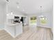 Bright, open kitchen with white cabinets, stainless steel appliances, and an island at 13573 Sw 115 Pl, Dunnellon, FL 34432