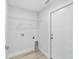 Laundry room with washer/dryer hookups, shelving, and a door at 13573 Sw 115 Pl, Dunnellon, FL 34432