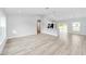 Spacious living room featuring wood-look flooring, high ceilings, and open access to the kitchen at 13573 Sw 115 Pl, Dunnellon, FL 34432