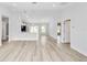 Bright and airy living space with wood-look floors, high ceilings, and open sightlines to the kitchen at 13573 Sw 115 Pl, Dunnellon, FL 34432