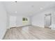 Inviting open-concept living room with wood-look flooring, high ceilings, and lots of natural light at 13573 Sw 115 Pl, Dunnellon, FL 34432