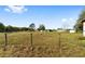 Spacious backyard with a wooden fence and outbuildings at 14136 Sw 8Th Ave, Ocala, FL 34473