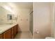 Clean bathroom with double vanity, wood cabinets and shower/tub combo at 14136 Sw 8Th Ave, Ocala, FL 34473