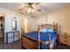 Bedroom with wooden bed frame, blue bedding and en-suite bathroom at 15077 Sw 37Th Ter, Ocala, FL 34473