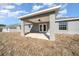 Spacious covered patio with ceiling fan and grassy backyard at 281 Locust Pass, Ocala, FL 34472