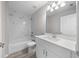 Clean bathroom with white vanity, marble-look shower, and modern fixtures at 281 Locust Pass, Ocala, FL 34472