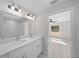 White bathroom vanity with marble tile and two sinks at 281 Locust Pass, Ocala, FL 34472