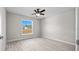 Spacious bedroom with large window, wood-look floors, and ceiling fan at 281 Locust Pass, Ocala, FL 34472