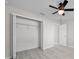 Bedroom featuring wood-look flooring, open closet, and ceiling fan at 281 Locust Pass, Ocala, FL 34472