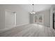 Dining room with modern light fixture and double doors at 281 Locust Pass, Ocala, FL 34472