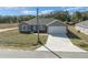 Elevated view of a gray, single-story home with attached garage and driveway at 281 Locust Pass, Ocala, FL 34472