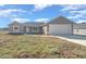 New construction home with a one-car garage and a large front yard at 281 Locust Pass, Ocala, FL 34472