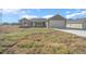 New construction home with a one-car garage and a large front yard at 281 Locust Pass, Ocala, FL 34472