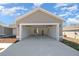 View of an open two-car garage with a concrete driveway at 281 Locust Pass, Ocala, FL 34472