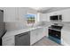 Bright kitchen boasts white shaker-style cabinets, stainless appliances, and ample counter space at 281 Locust Pass, Ocala, FL 34472