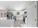 Kitchen with stainless steel appliances, white cabinets, light countertops, and wood-look flooring at 281 Locust Pass, Ocala, FL 34472