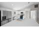Kitchen with white shaker cabinets, stainless steel appliances, and wood-look flooring at 281 Locust Pass, Ocala, FL 34472