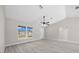 Spacious living area with vaulted ceilings and several windows offering natural light at 281 Locust Pass, Ocala, FL 34472