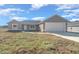 Front view of a new single-story home with gray exterior and attached two-car garage at 283 Locust Pass, Ocala, FL 34472