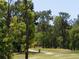 Scenic view of the golf course amidst lush trees at 320 Hickory Course Trl, Ocala, FL 34472