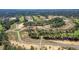 A high angle view of a housing development with lots of greenery and winding roads at 328 Hickory Course Trl, Ocala, FL 34472