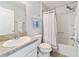 Clean bathroom with tub shower, toilet and vanity at 3319 Rohan Rd, Oxford, FL 34484