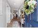 Bright entryway with a navy blue door, hardwood floors, and a console table at 3319 Rohan Rd, Oxford, FL 34484